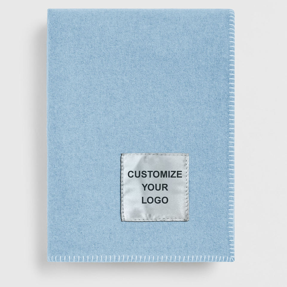 Corporate gift throw blanket with woven label